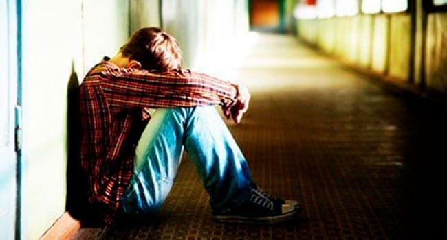 Depressed young man contemplating suicide Canada mishandling mental illness crisis